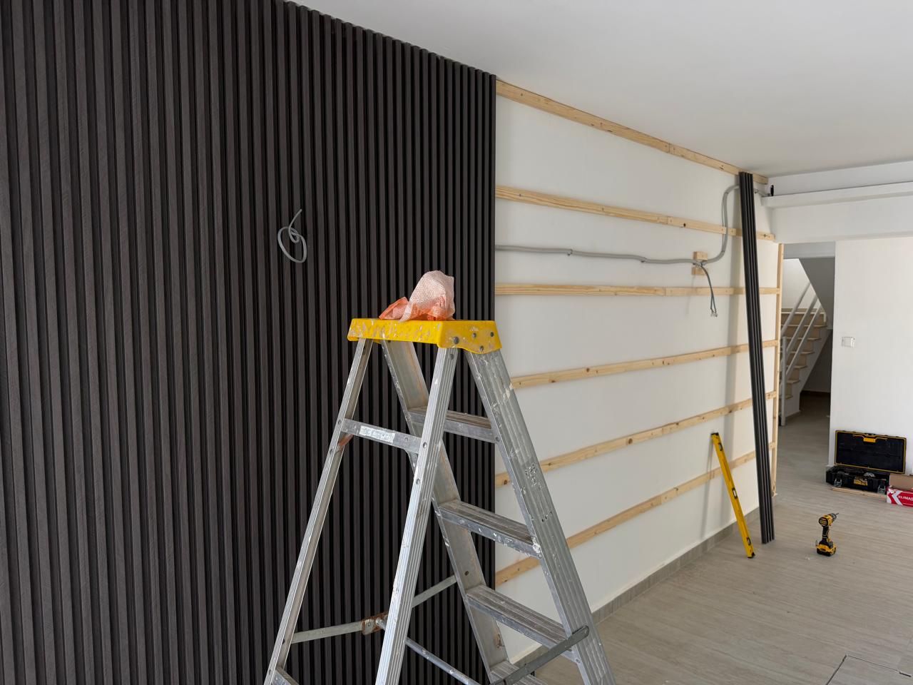 Decorative wall panelling being installed in an apartment building entrance