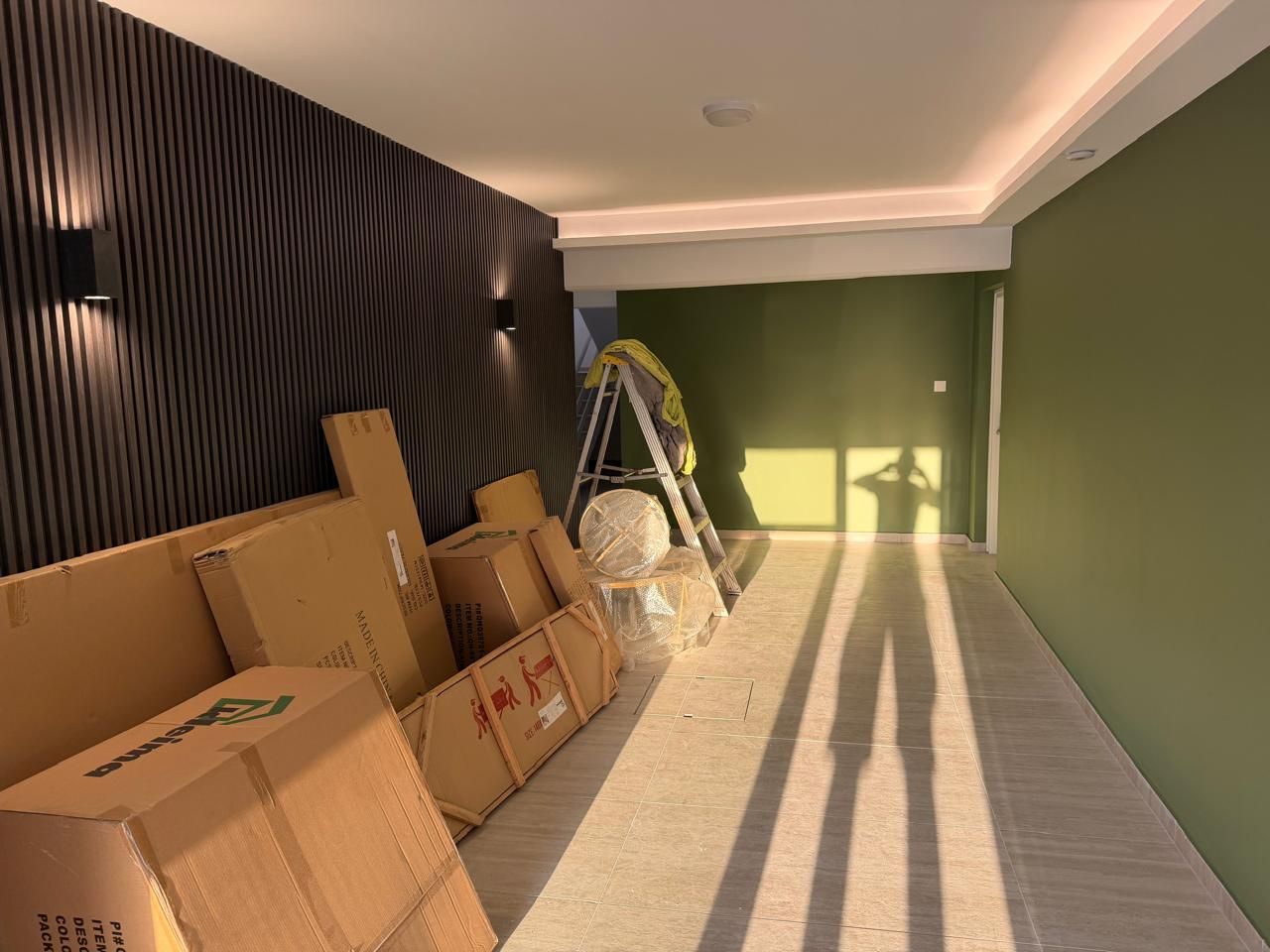 Apartment building entrance during renovation with new wall panelling and lighting