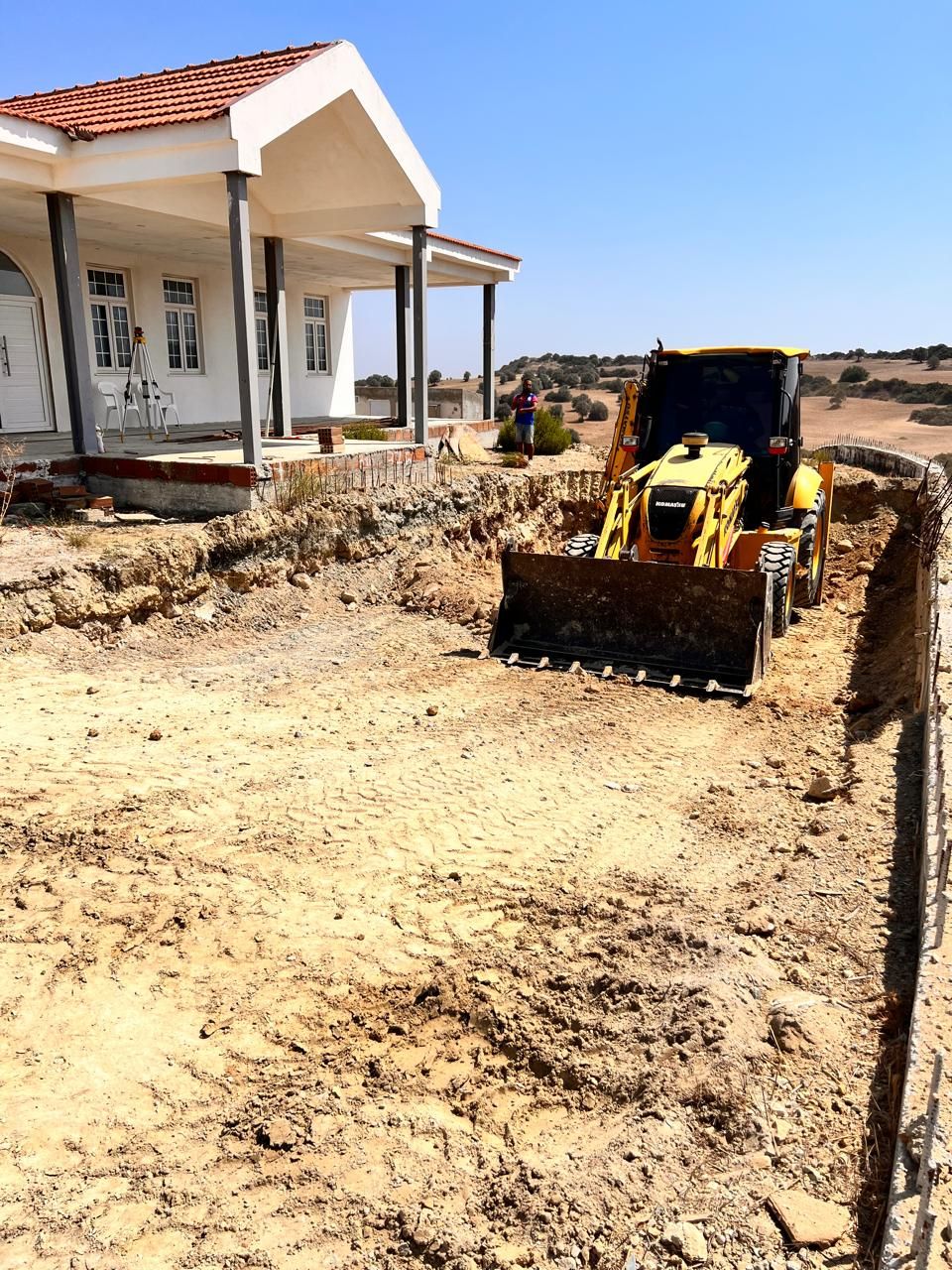 Swimming pool construction beside residential property