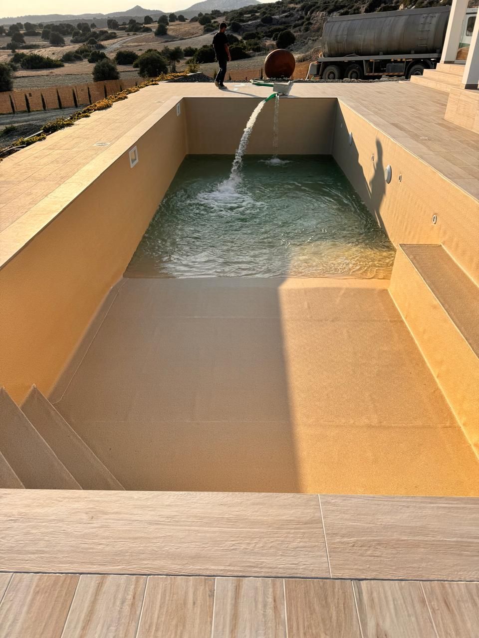 New swimming pool being filled with water