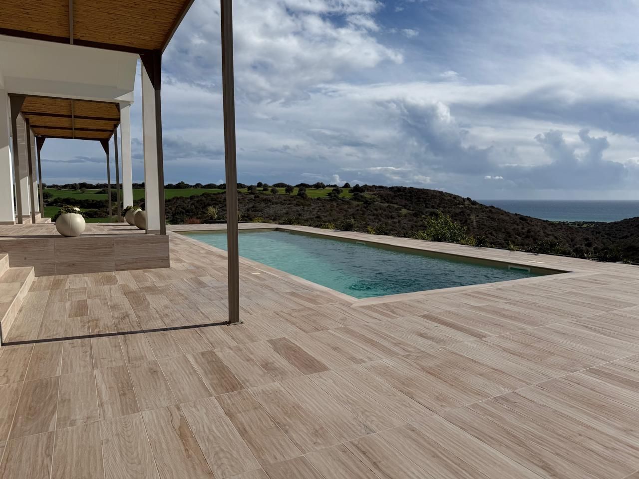 Newly built swimming pool and terrace overlooking the Cyprus countryside and sea